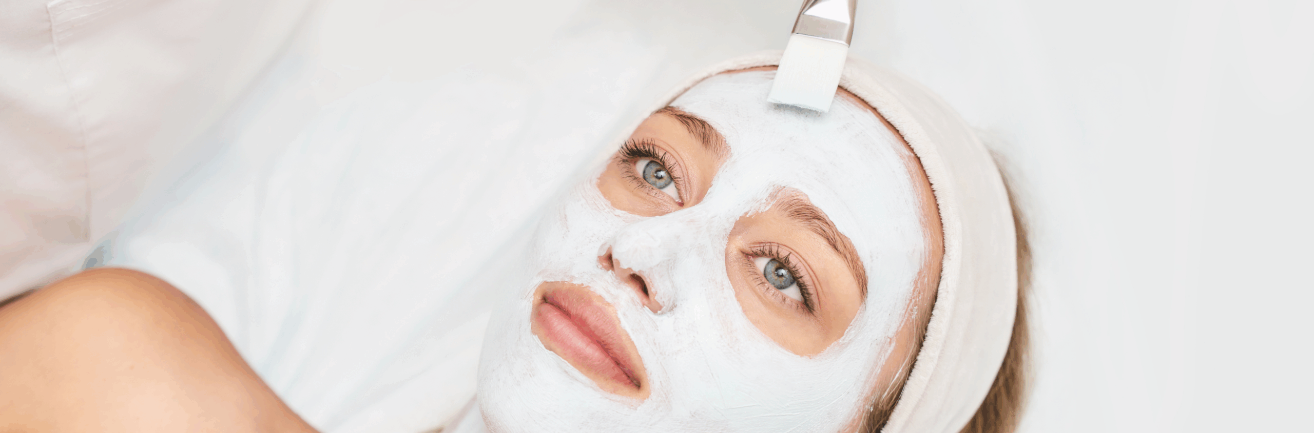 Model receiving a professional facial treatment by an esthetician
