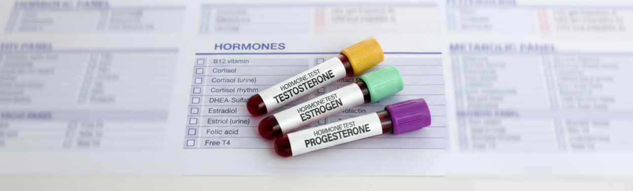 Three test tubes with different colors on them depicting hormone therapy.